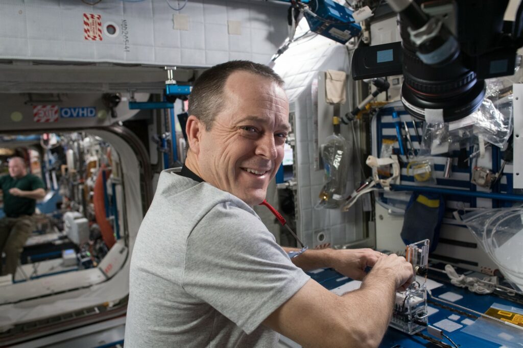 NASA Astronaut and Flight Engineer Ricky Arnold works with a student designed Genes in Space 5 experiment inside the Harmony module.