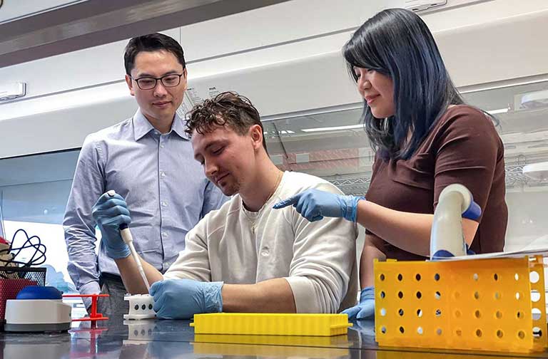 upward-81-janus-uconn-chen-grad-student Yupeng Chen and graduate students Ian Sands and Anne Yau prepare their experiment for launch on NG-20.