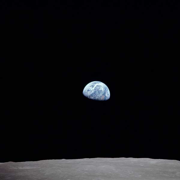 In December 1968, the first crew to orbit the moon snapped this iconic photo, showing our colorful blue and white planet rising above the drab gray lunar surface.