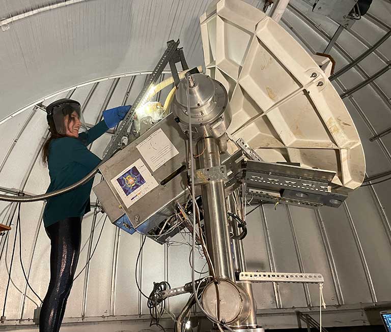 Kaylie Hausknecht filling a dewar with liquid nitrogen at the Harvard-Smithsonian Center for Astrophysics 1.2-meter telescope