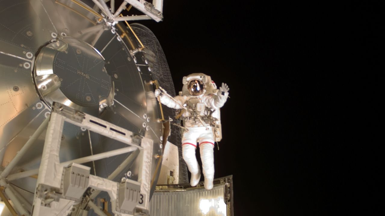 Conductor Astronaut Rex Walheim evokes the mannerisms of a conductor while on a space walk.