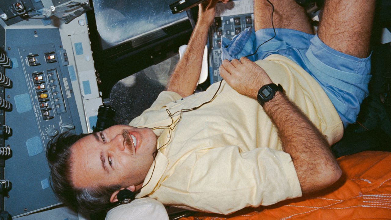 Creighton-headphones STS-36 Commander John Creighton listening to music through a headset.