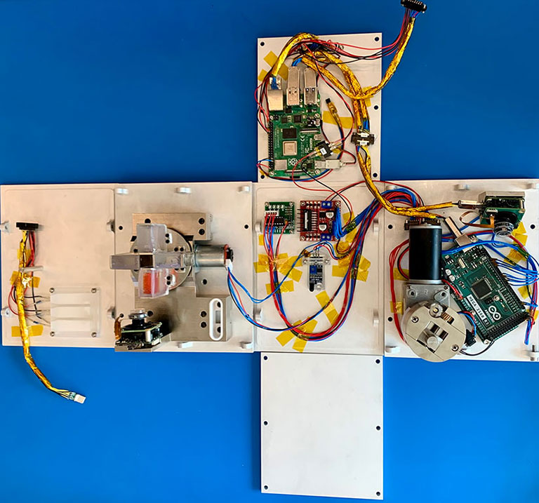 Unfolded ICECUBES hardware with the shaking system and four fluid-containing cells.