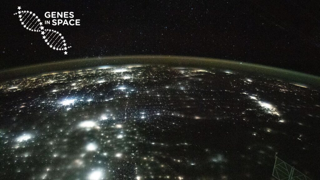 The city lights of North America appear under Earth's airglow and a starry night sky in this photograph from the International Space Station as it orbited 262 miles above Earth. Paired with the Genes in Space logo.