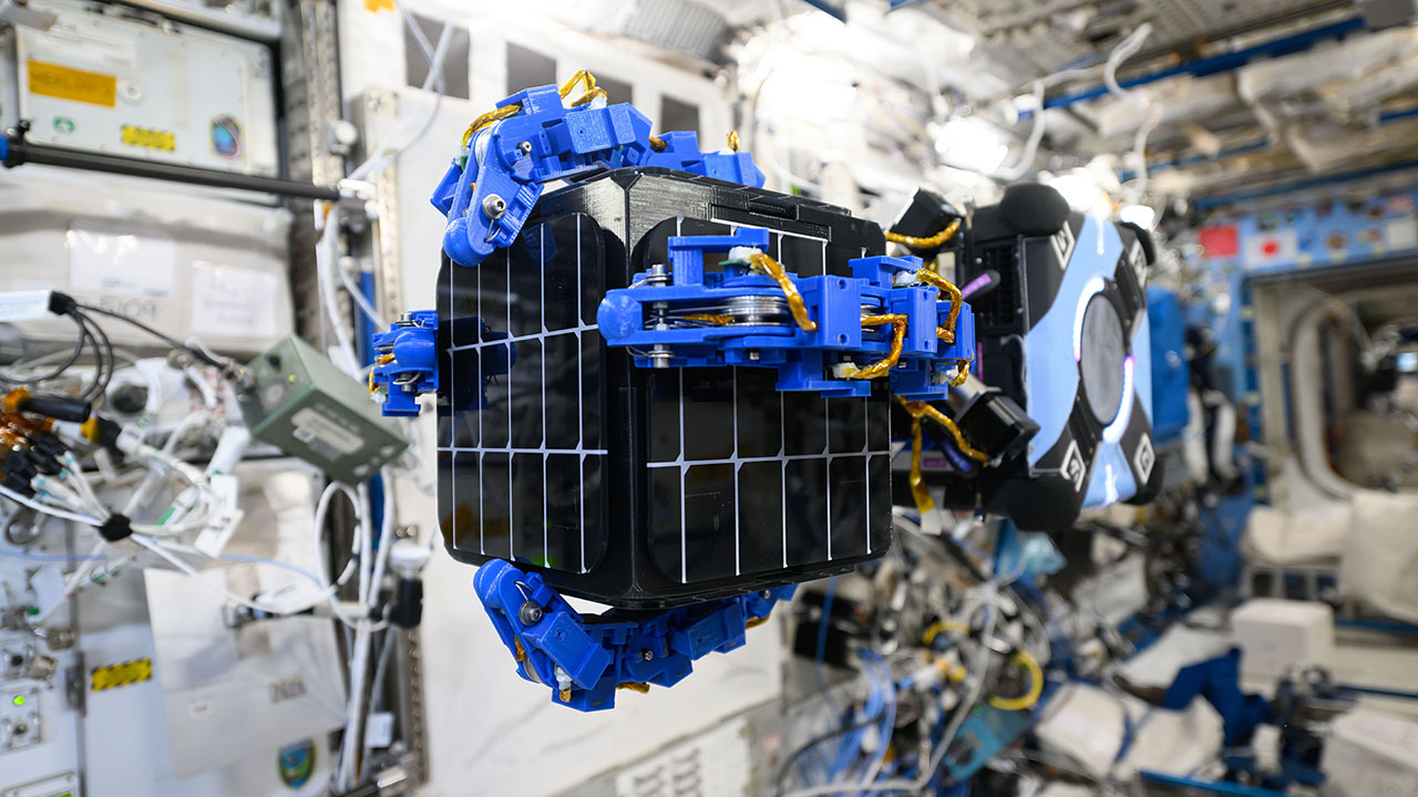 REACCH's arms successfully capture and grip a target object during testing on the ISS.