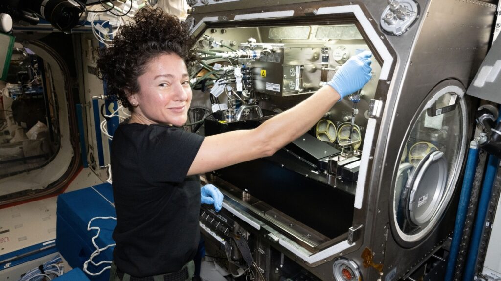 NASA astronaut Jessica Meir configures research gear inside the Microgravity Science Glovebox aboard the International Space Station.