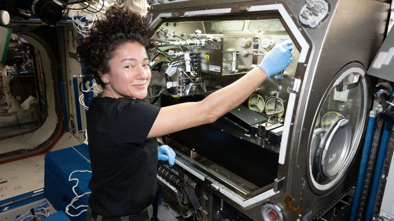 NASA astronaut Jessica Meir configures research gear inside the Microgravity Science Glovebox aboard the International Space Station.